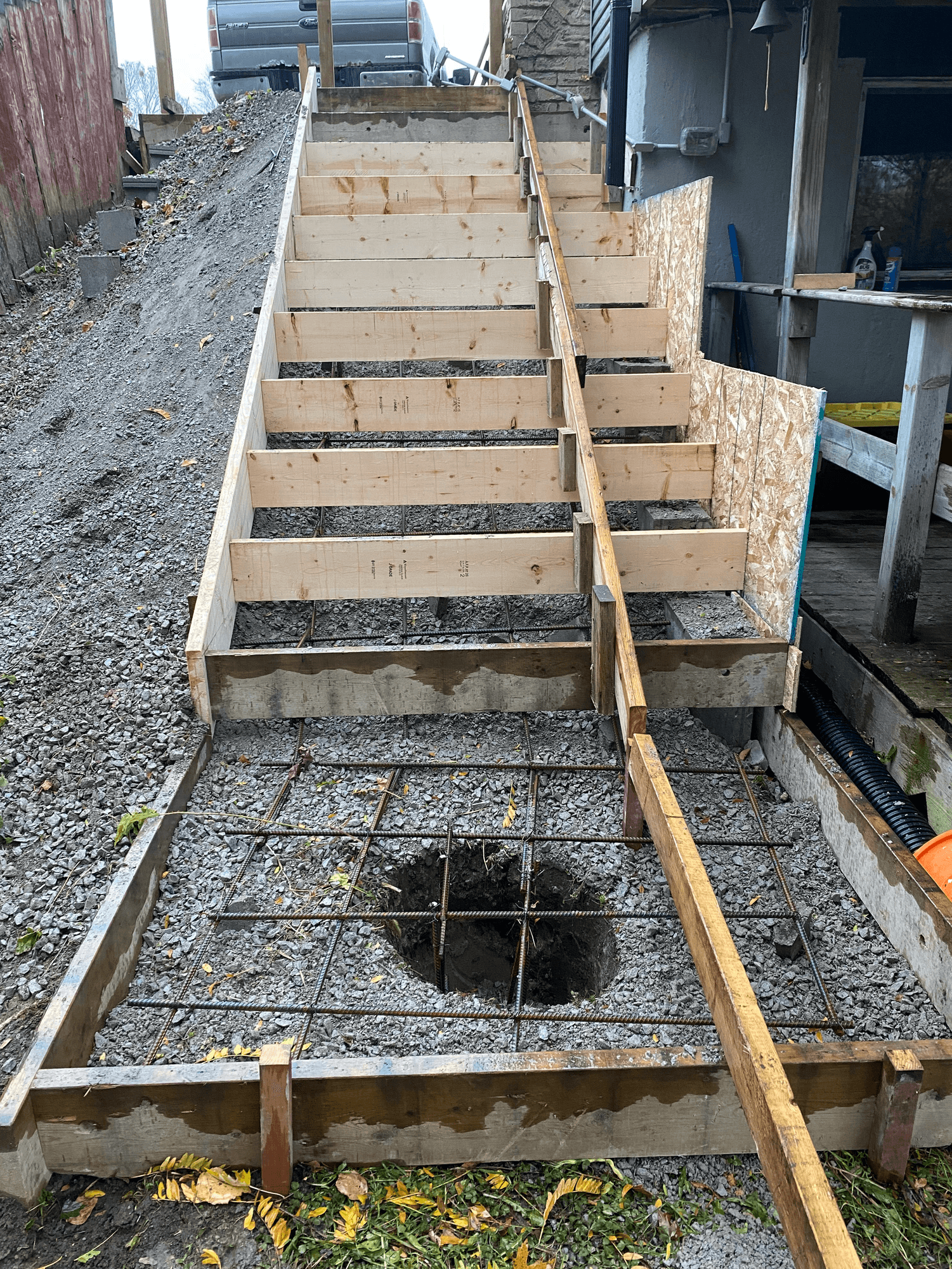 Formwork and rebar set on a gravel base for new exterior concrete steps
